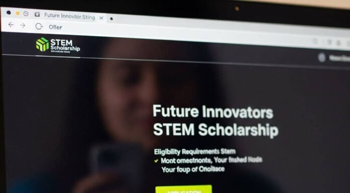 Scholarships Every Woman in STEM Should Apply For A blurry image of a laptop screen with a STEM scholarship site and a sticky note that reads "You Got This, Idiot."