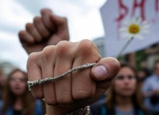 Fighting for Choice: The Women Leading the Movement Gritty protest scene, woman's fist with worn bracelet, dripping sign, daisy in megaphone.