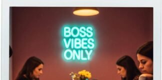 Why Women Are the Future of Entrepreneurship Polaroid of women working in a messy co-working space with a neon sign.