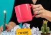 7 Empowering Ways Women Are Fighting Back at Work A vibrant desk scene: hand slamming a neon-pink mug on crumpled papers.